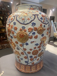 An exceptionally large Chinese Imari-style vase and cover with molded floral design, Kangxi
